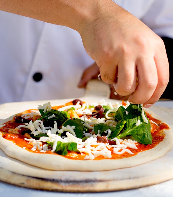 Behind the Dough: The Art of Crafting Pizza at Pizza Station