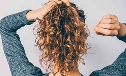 How can you effectively manage frizzy hair for a smoother appearance?
